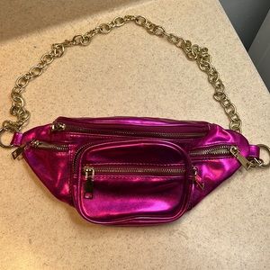 Hot pink fanny pack with gold chain.